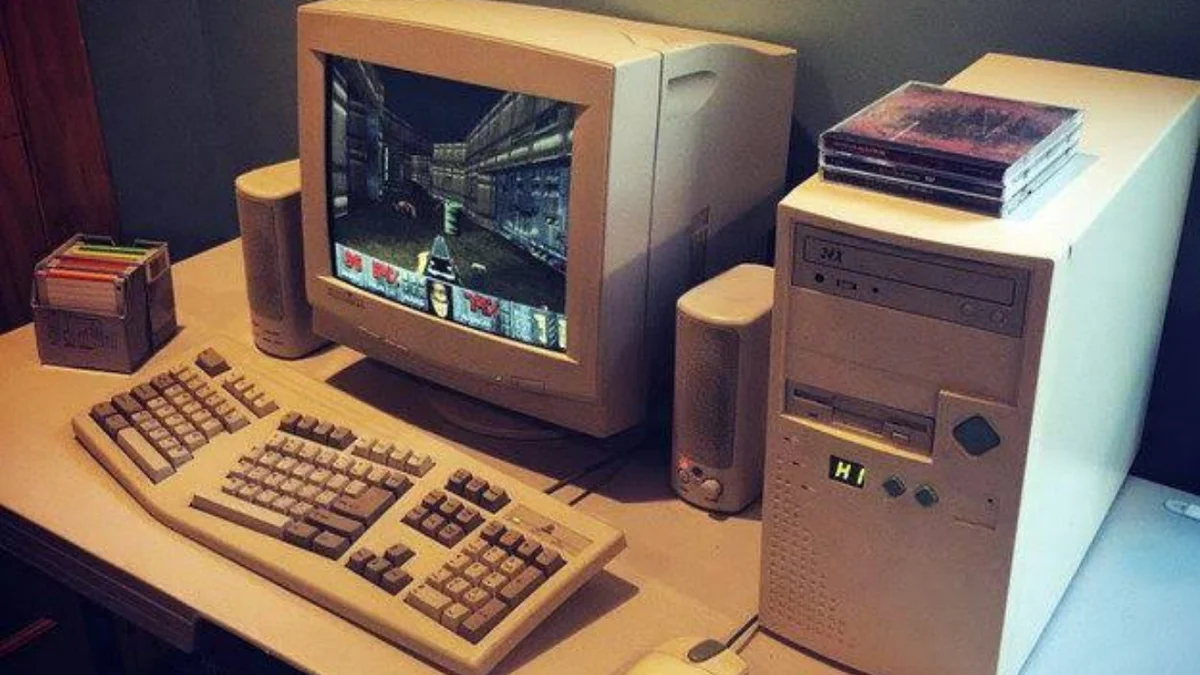 a vintage pc with doom on the screen